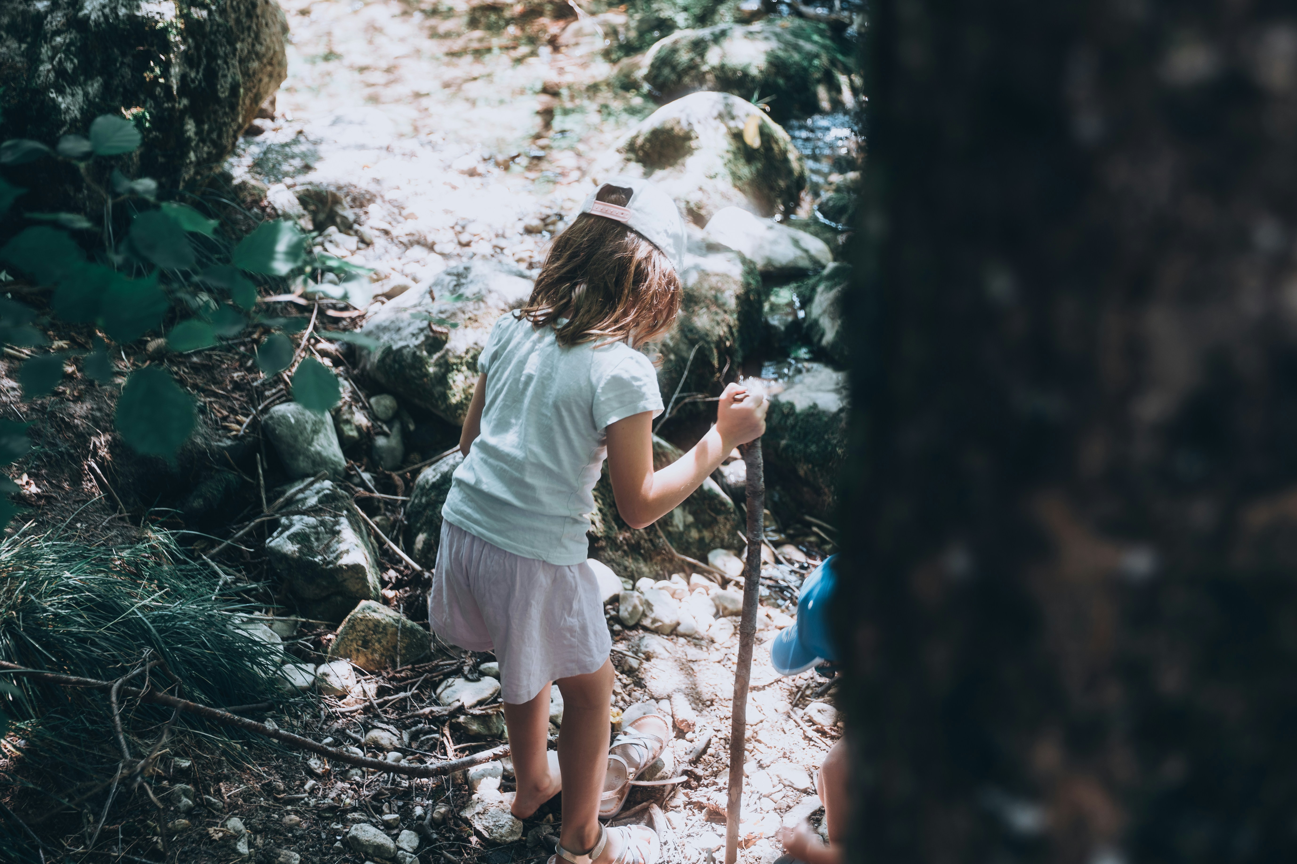 Young girl hiking on a forest path